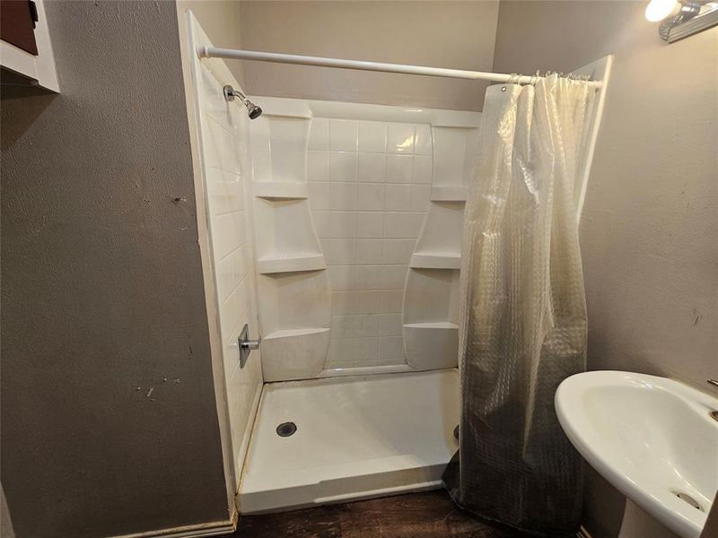 Bathroom featuring a shower with curtain and sink Bathroom featuring a shower with curtain and sink