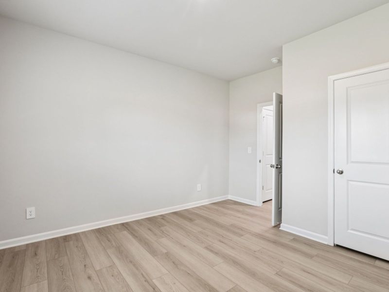 Secondary bedroom in the Paisley floorplan at a Meritage Homes community in Garner, NC.