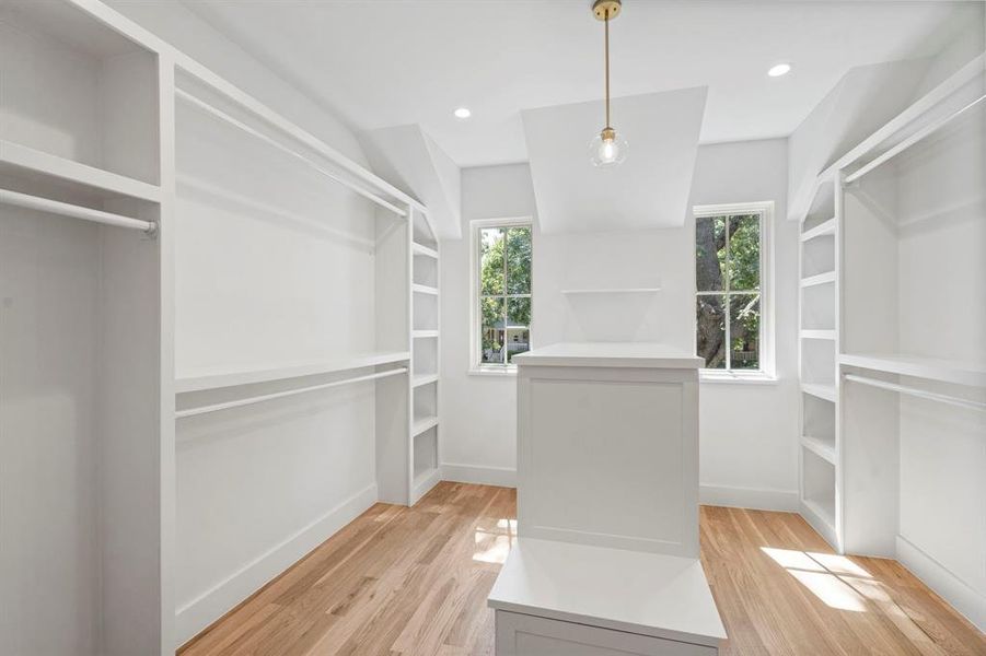 Spacious closet with light hardwood / wood-style flooring