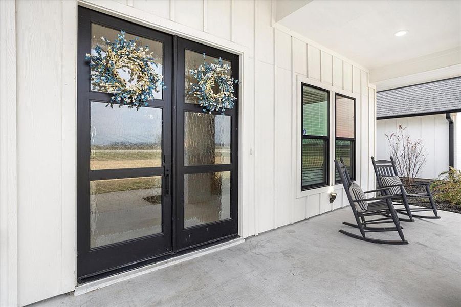 Entrance to property with covered porch and french doors