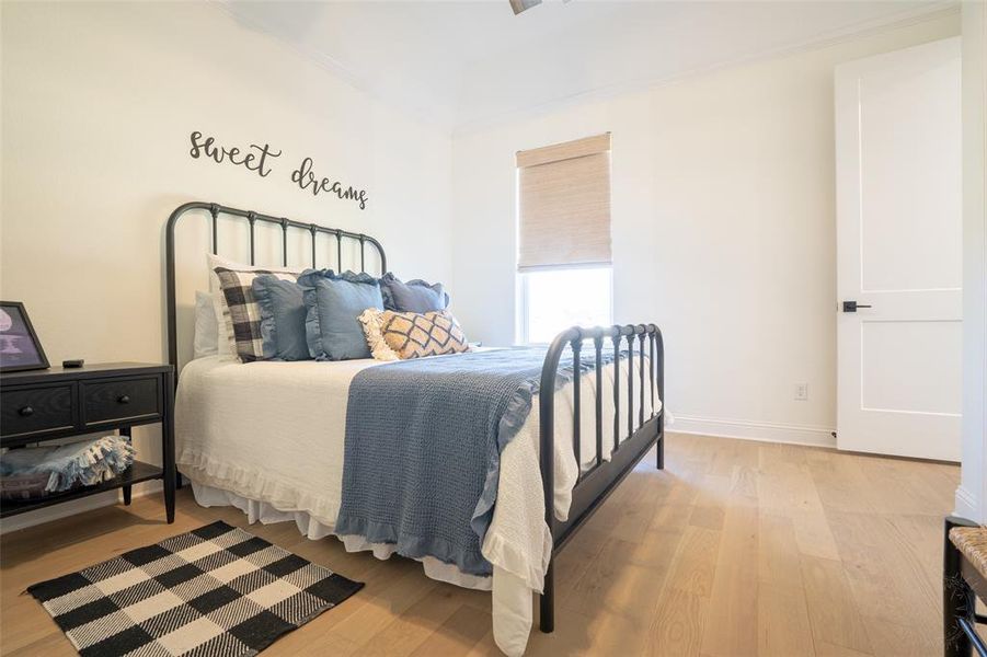 Bedroom with light wood-type flooring and baseboards Bedroom with light wood-type flooring and baseboards