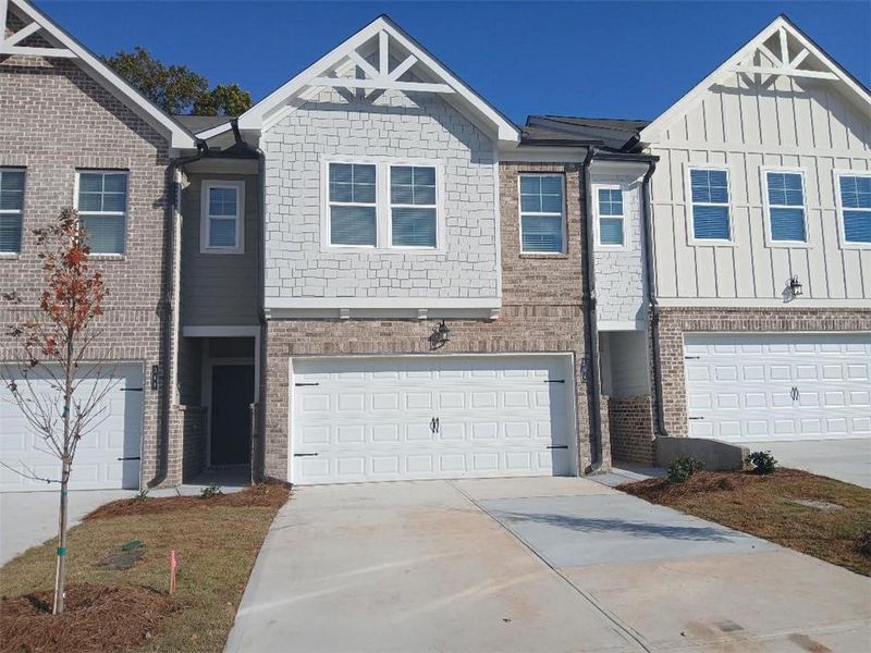 Front exterior of a new home in Union Village, McDonough, GA, highlighting curb appeal (Image 2). Front exterior of a new home in Union Village, McDonough, GA, highlighting curb appeal (Image 2).