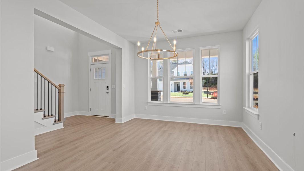 Elegant family room with hardwood flooring and open-concept flow in this first-class DRB Homes design