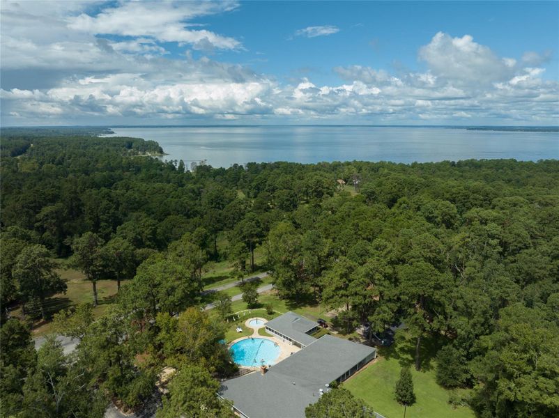This aerial view showcases the community pool, nestled within a beautifully landscaped area. Surrounded by lush greenery, it offers a peaceful and inviting space to relax, swim, and enjoy sunny days in a tranquil setting. Perfect for both socializing and unwinding, this pool is a true highlight of the community. This aerial view showcases the community pool, nestled within a beautifully landscaped area. Surrounded by lush greenery, it offers a peaceful and inviting space to relax, swim, and enjoy sunny days in a tranquil setting. Perfect for both socializing and unwinding, this pool is a true highlight of the community.