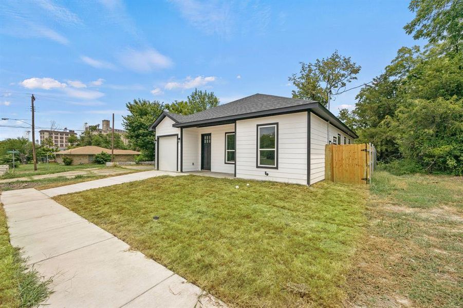 View of front of house with a garage and a front yard