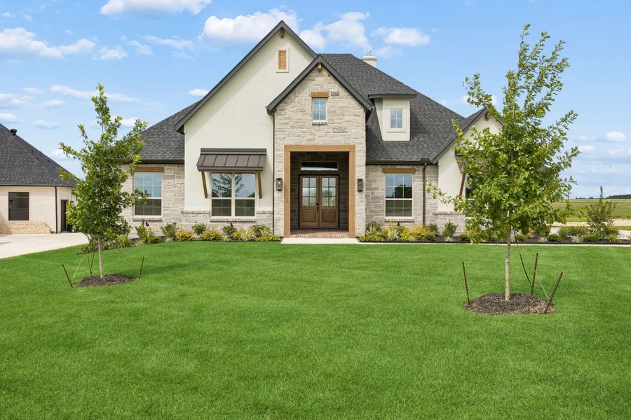 Front exterior of a new home in The Retreat, Cleburne, TX, highlighting curb appeal (Image 2). Front exterior of a new home in The Retreat, Cleburne, TX, highlighting curb appeal (Image 2).