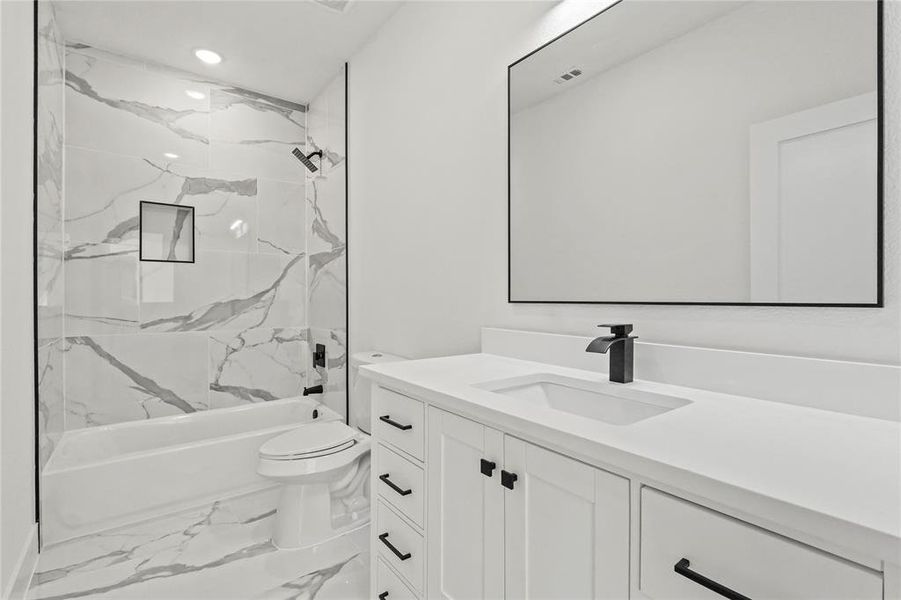 Full bathroom featuring vanity, marble finish flooring, bathtub / shower combination, and recessed lighting