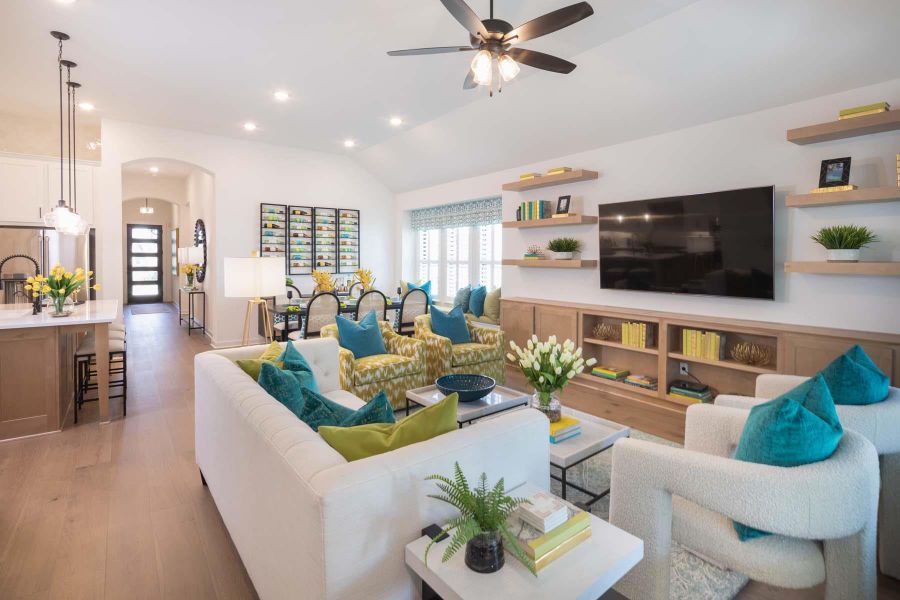 Living room featuring light wood finished floors, ceiling fan, lofted ceiling, recessed lighting, and arched walkways