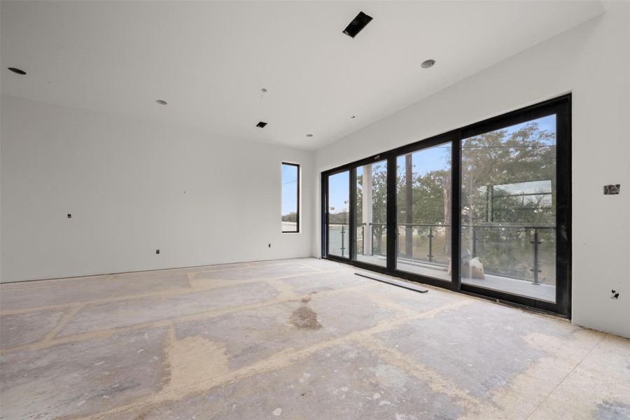 Private primary suite thoughtfully positioned apart from secondary bedrooms, featuring a spacious walk-in closet and direct access to a secluded balcony.