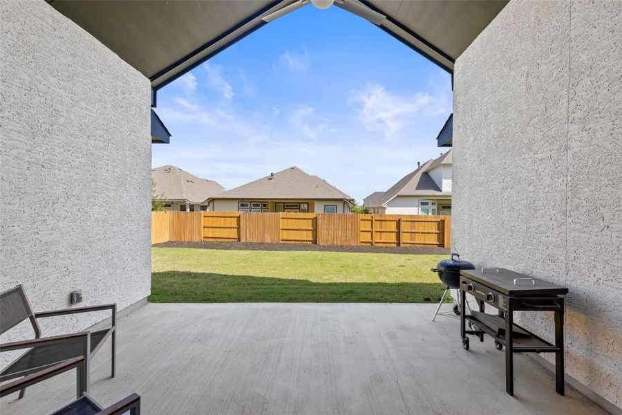 Sliding doors open to an expansive covered patio with a gas drop, perfect for al fresco evenings