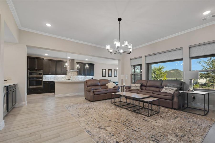 The living room with its dry bar and beverage fridge opens right into the kitchen.