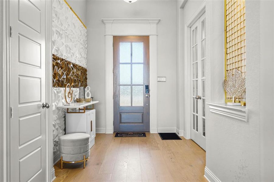 Entryway featuring wood finished floors and french doors Entryway featuring wood finished floors and french doors