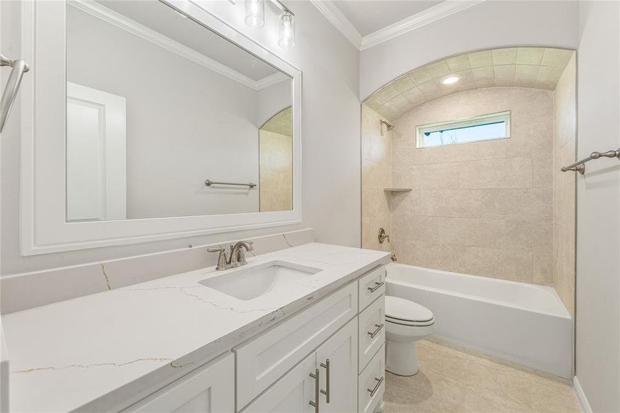 Full bathroom with shower / bath combination, vanity, crown molding, and light tile patterned flooring Full bathroom with shower / bath combination, vanity, crown molding, and light tile patterned flooring