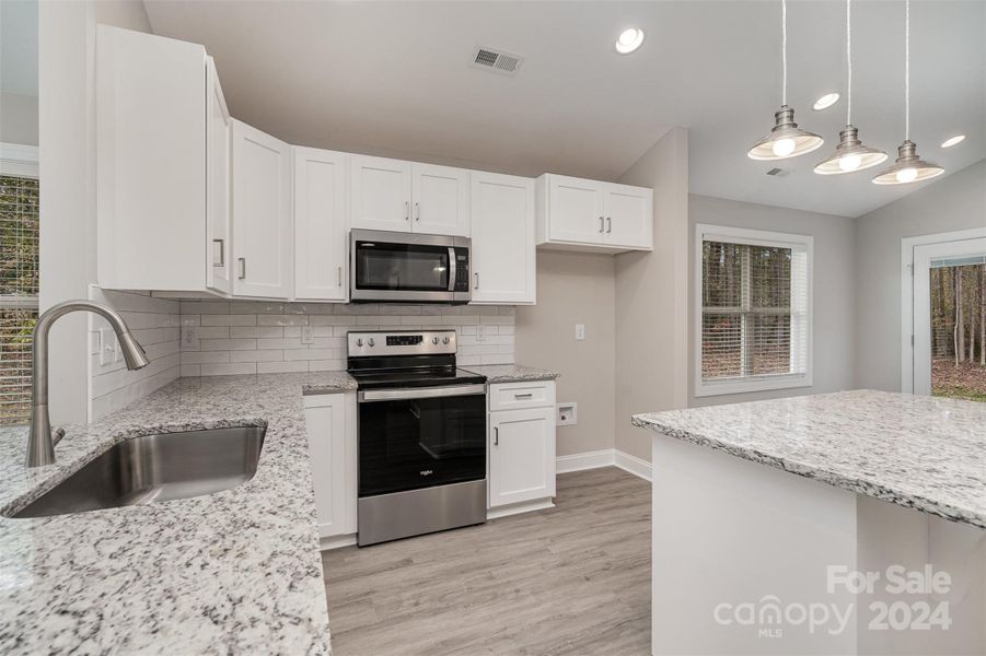 Beautiful, bright kitchen with kitchen island.