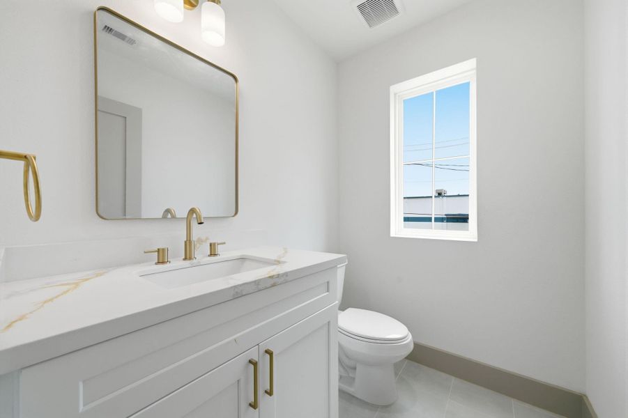 The half bath is close by to the entertaining space, yet provides plenty of privacy