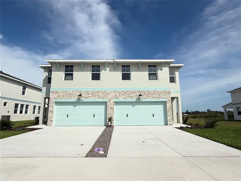 Front exterior of a new home in Emerald Fields, Hudson, FL, highlighting curb appeal (Image 1). Front exterior of a new home in Emerald Fields, Hudson, FL, highlighting curb appeal (Image 1).