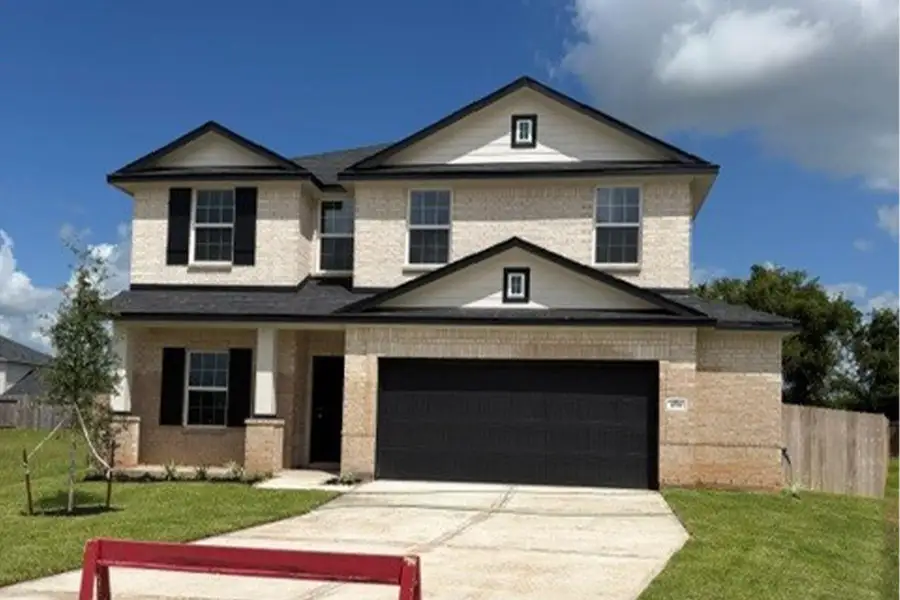 Front exterior of a new home in Bluestem, Brookshire, TX, highlighting curb appeal (Image 2). Front exterior of a new home in Bluestem, Brookshire, TX, highlighting curb appeal (Image 2).