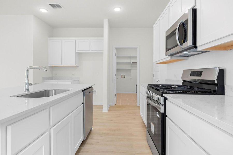 Kitchen in the Magnolia home plan by Trophy Signature Homes – REPRESENTATIVE PHOTO