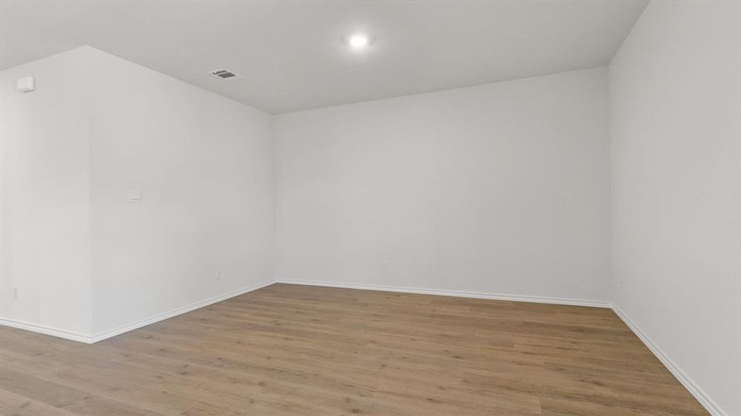 Empty room featuring wood finished floors and baseboards