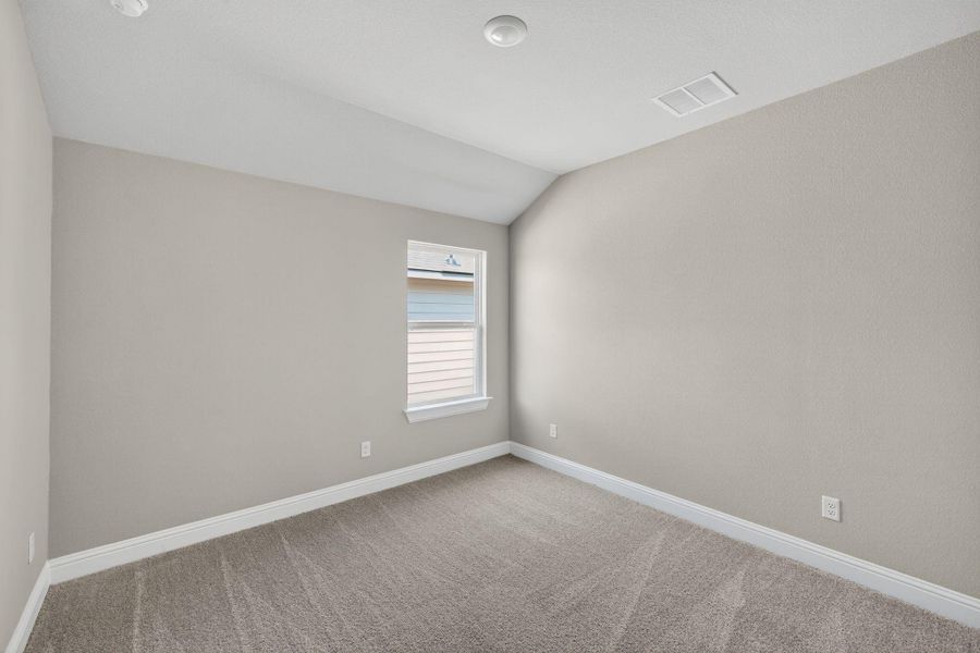 Spare room with lofted ceiling and carpet flooring Spare room with lofted ceiling and carpet flooring