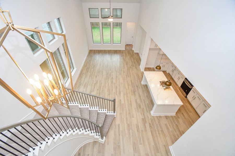 stylish mezzanine-level view of the living and kitchen areas below, ideal for showcasing the home’s openness.