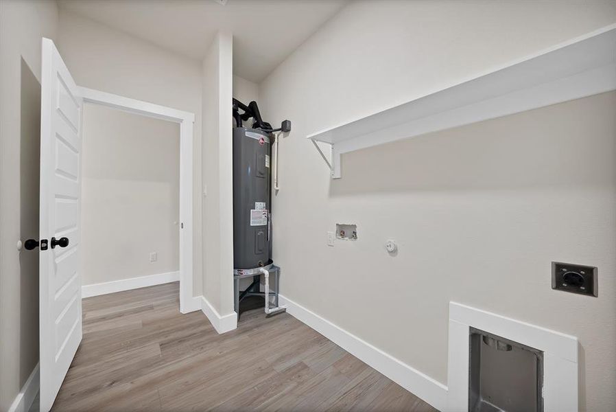 Laundry area with hookup for a gas dryer, light wood-style floors, hookup for an electric dryer, electric water heater, and hookup for a washing machine