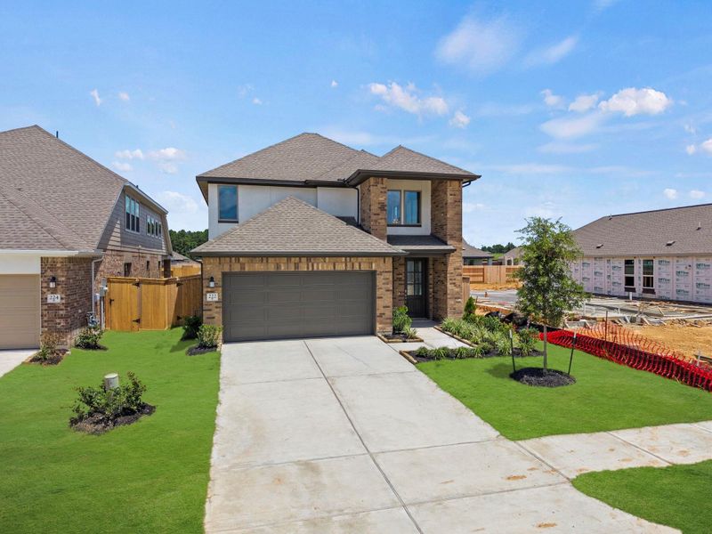 Front exterior of a new home in The Trails, New Caney, TX, highlighting curb appeal (Image 14).