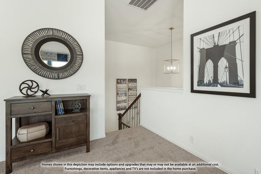 Upstairs hallway landing with dark wood console table, round mirror, pendant light, and staircase railing Upstairs hallway landing with dark wood console table, round mirror, pendant light, and staircase railing