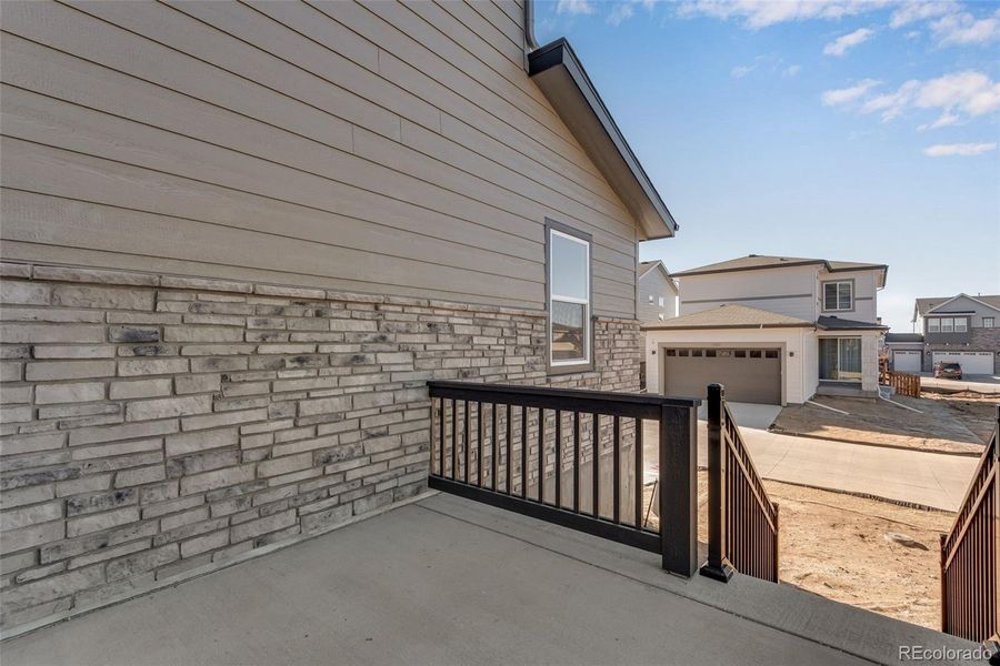 Exterior details and patio area of a home in Crescendo at The Aurora Highlands, Aurora (Image 3).