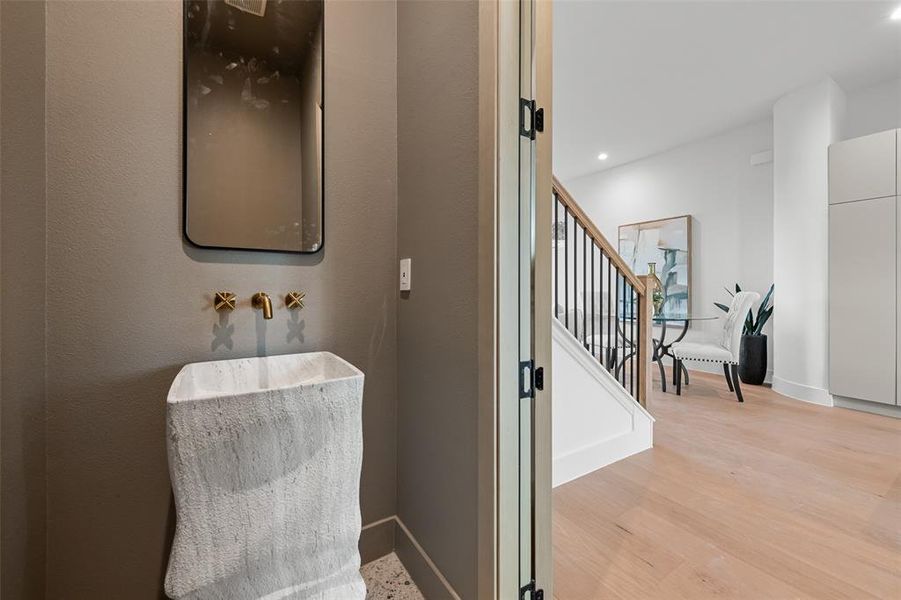 Stairs with wood finished floors and recessed lighting