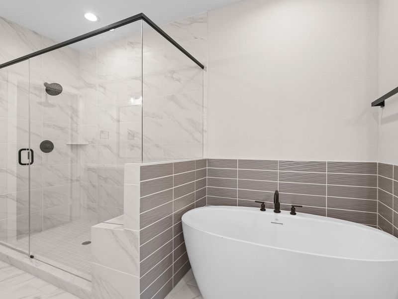 Enjoy your luxurious spa-style bath with dual vanities and an oversized walk-in shower for a true daily escape. Image depicts home as-is.