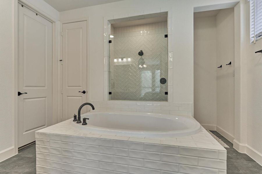 Indulge in ultimate relaxation with this elegant bathroom's centerpiece—a luxurious soaking tub perfect for unwinding.