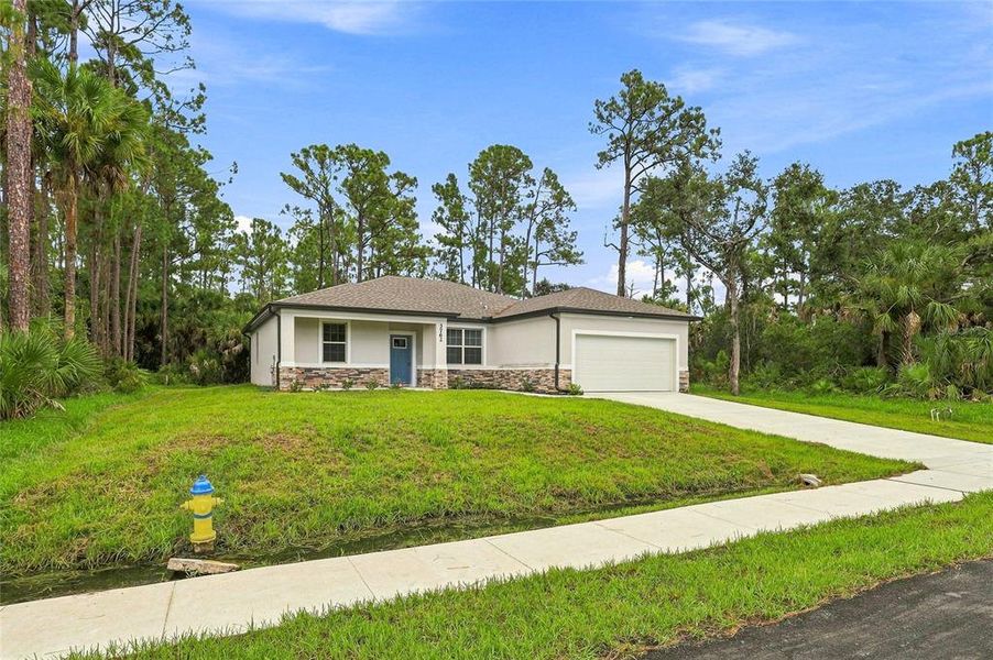 Front exterior of a new home in , North Port, FL, highlighting curb appeal (Image 18).