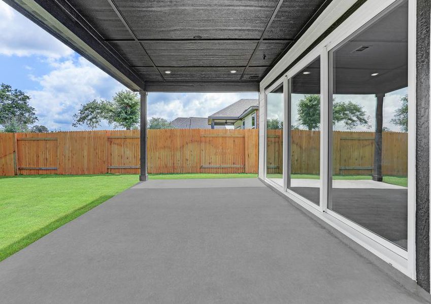 Covered back patio with direct access to the living room through the large sliding glass doors.