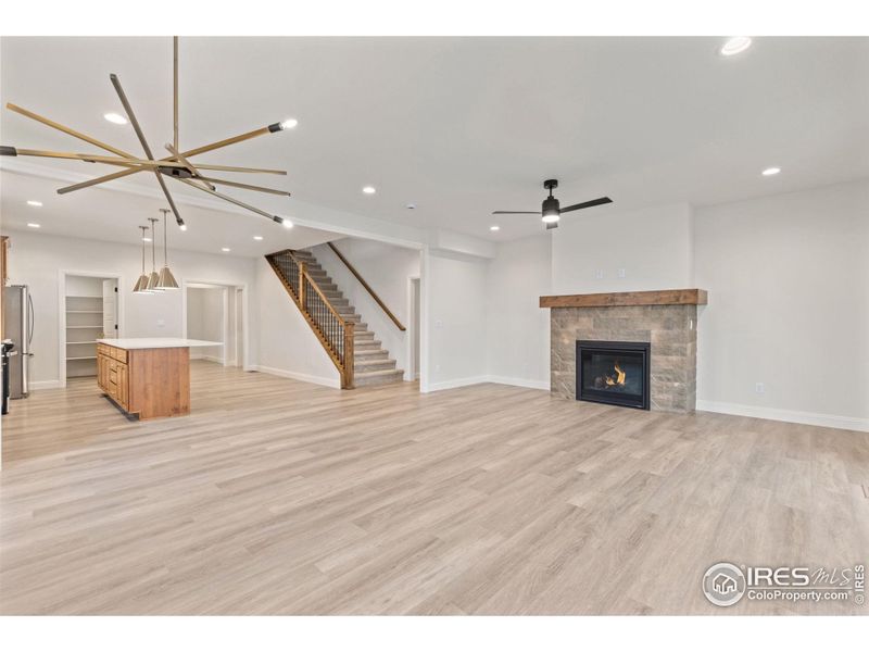 The living room fireplace is seen from the dining room and kitchen as well