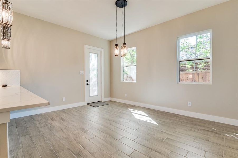 Breakfast area, natural light, a notable chandelier, and Ceramic Tile wood finished floors Breakfast area, natural light, a notable chandelier, and Ceramic Tile wood finished floors