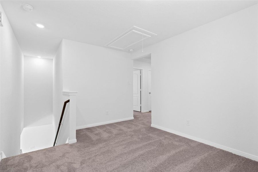 Another perspective from the Loft, showcasing the staircase and hallway leading to the secondary bedrooms. Another perspective from the Loft, showcasing the staircase and hallway leading to the secondary bedrooms.