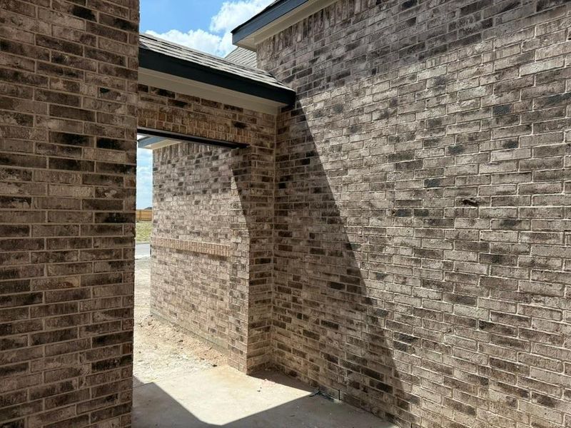 View of side of property featuring brick siding