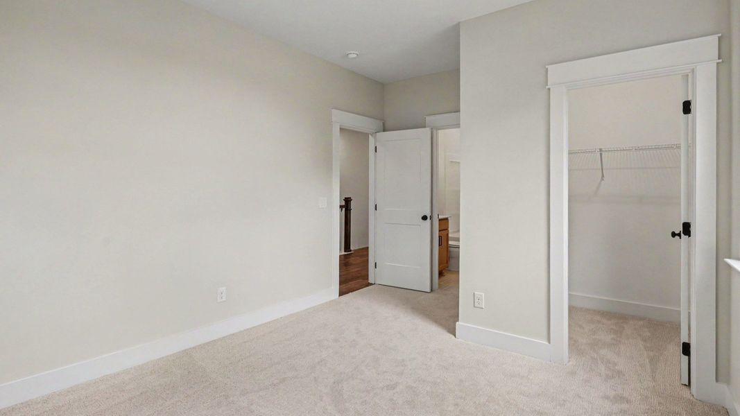 Bedroom with carpet and closet Bedroom with carpet and closet