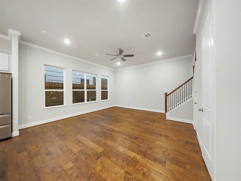 The living area is open and spacious, and the large windows allow plenty of natural light to come in. (Sample photo of a completed Sterling Floor Plan. Image may show alternative features/and or upgrades.)