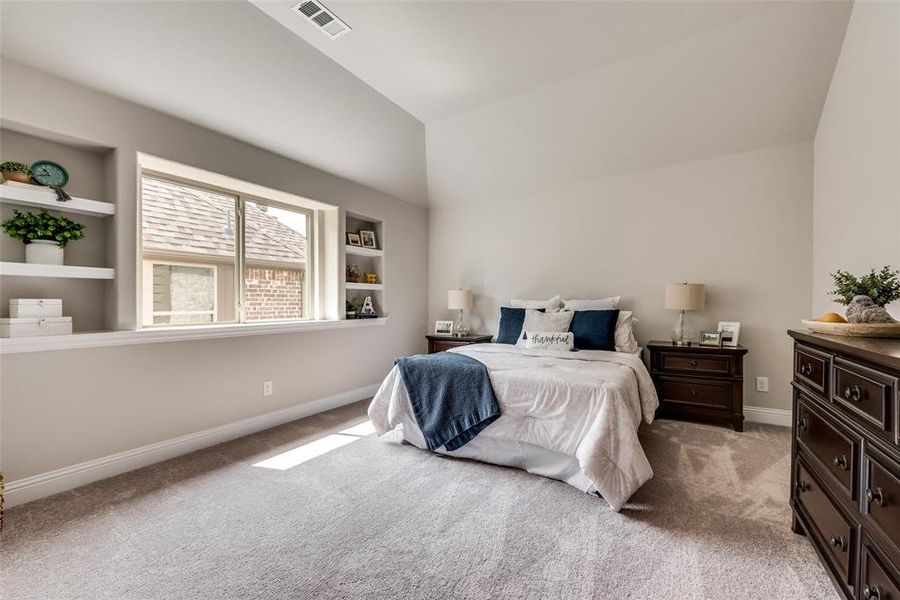 Large upstairs bedroom with built-in shelving would be great as a second master or guest suite.