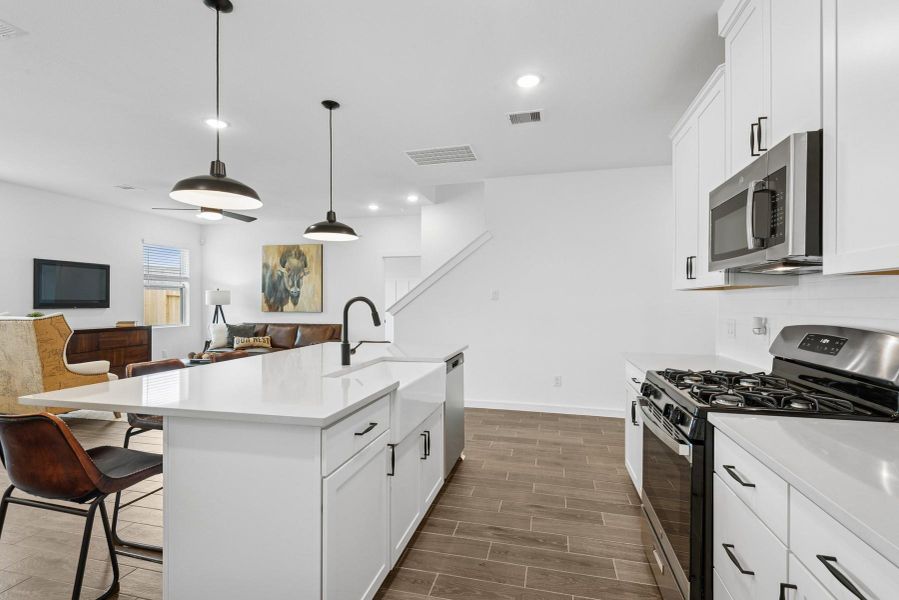 Soft white cabinets and quartz countertops (*Photo not of actual home and used for illustration purposes only.)