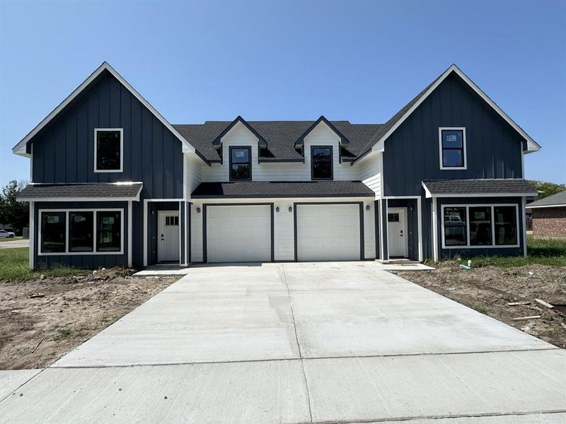Modern farmhouse style home with a shingled roof, board and batten siding, driveway, and an attached garage