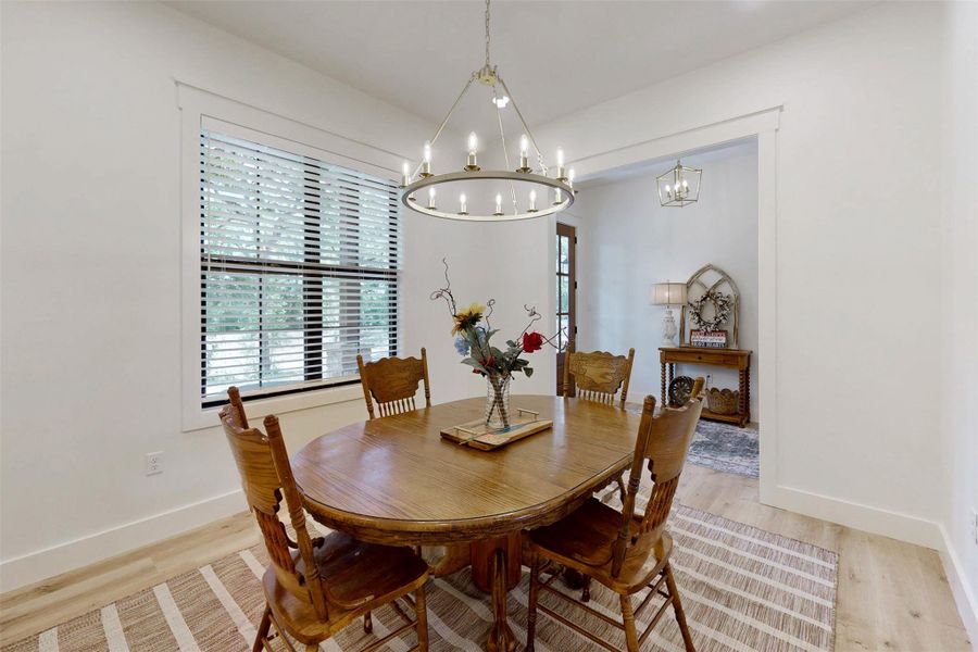 Dining space featuring a chandelier and light wood-style flooring