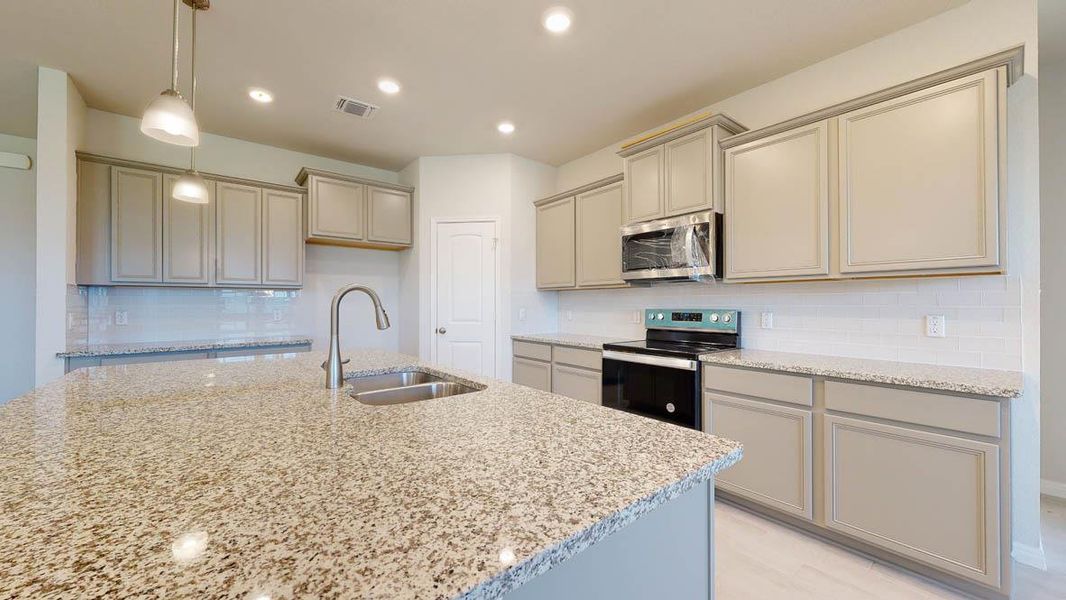 Kitchen with decorative backsplash, range with electric stovetop, hanging light fixtures, light stone counters, and recessed lighting