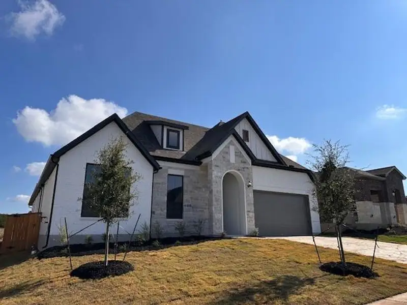 Front exterior of a new home in 6 Creeks, Kyle, TX, highlighting curb appeal (Image 2). Front exterior of a new home in 6 Creeks, Kyle, TX, highlighting curb appeal (Image 2).