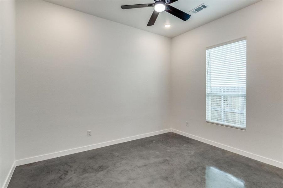 Carpeted empty room featuring ceiling fan