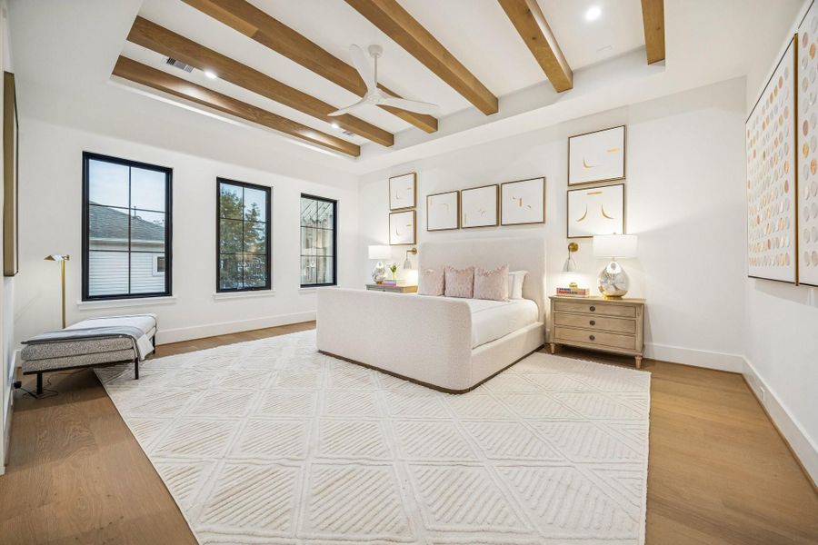 Primary Bathroom with 7 1/2 Inch Wide Plank, European White Oak Floors, Stained Oak boxed beams and a MinkaAire Roto XL 62" 3 Blade Ceiling Fan. There is also a set of side bed sconces.