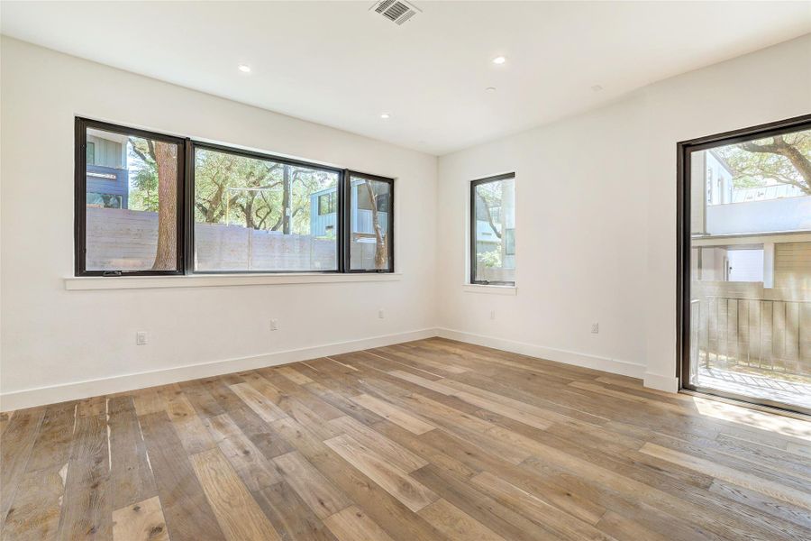 Spare room with light wood-style flooring, baseboards, and recessed lighting