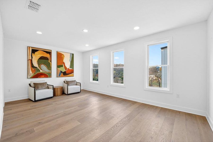 Unfurnished room with light wood-type flooring and recessed lighting